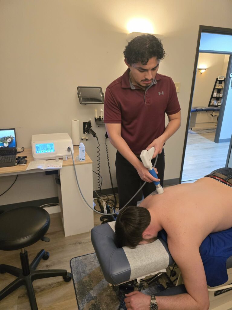Shockwave therapy treatment for upper back pain at Plano chiropractic clinic