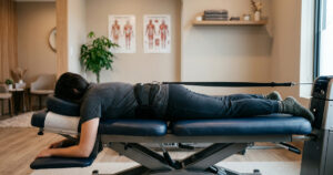 Non surgical back pain treatment Plano TX chiropractor reviewing spinal imaging with patient